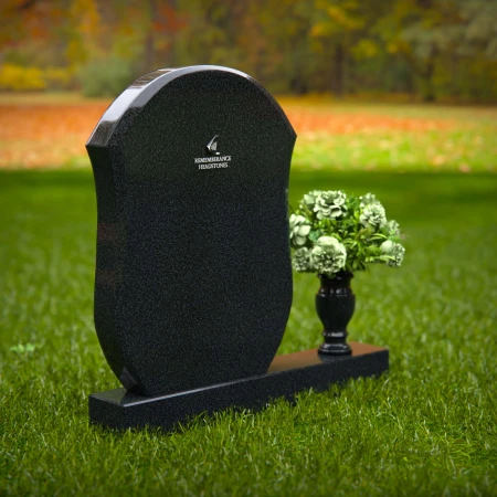 Unique granite headstones with rounded shield design and flower vase.