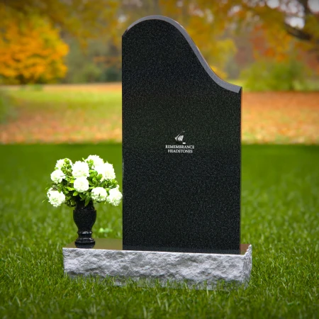 Elegant sloped headstones with floral vase for timeless tribute.