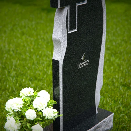Graceful asymmetrical granite headstones with cross, symbolizing faith and remembrance.
