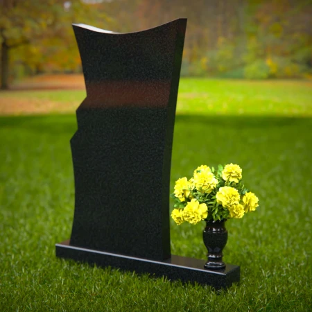 Contemporary granite memorial headstones with unique curved design.