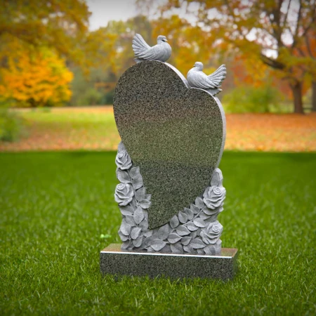 Doves rise around heart shape etched with floral memory in grave markers