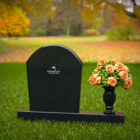 Classic arched granite headstones with single flower vase tribute.