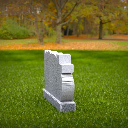 A carved cross and branching life tree define these headstone near me