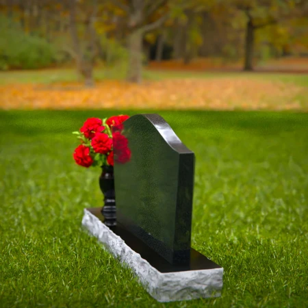 Waved granite headstones with single flower vase for graceful tribute.