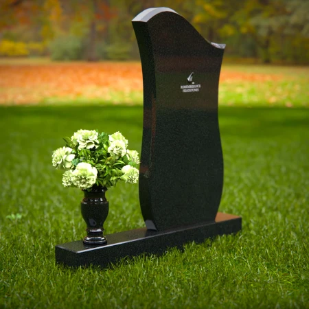 Contemporary granite headstones with unique curved design and vase.