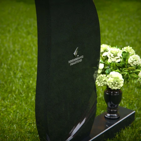 Modern curved headstones with single flower vase for memorials.