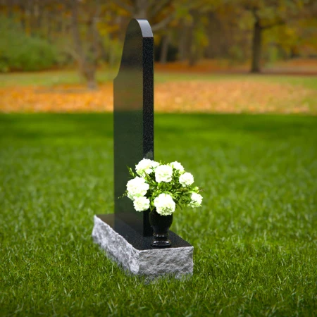 Elegant sloped headstones with floral vase for timeless tribute.