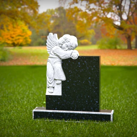 Carved children’s headstones with quiet angel watching over