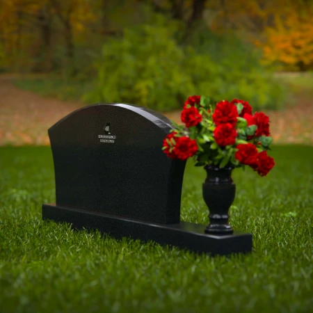 Contoured granite headstones with single flower vase for tribute.