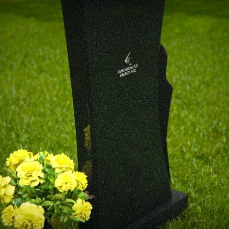 Contemporary granite memorial headstones with unique curved design.