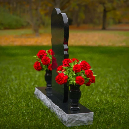 Unique dual heart headstones with twin flower vases for memorials.