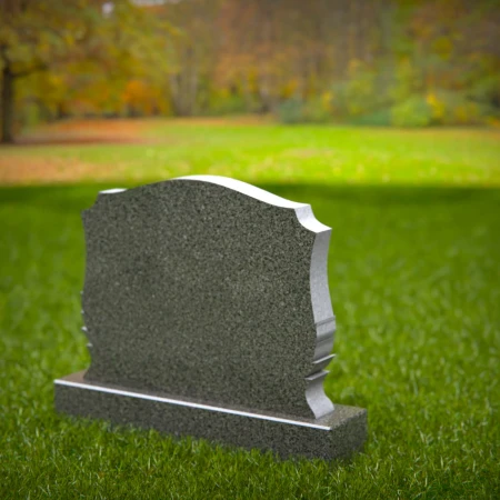 Memorial artistry flows through heart and leaf designs in headstones