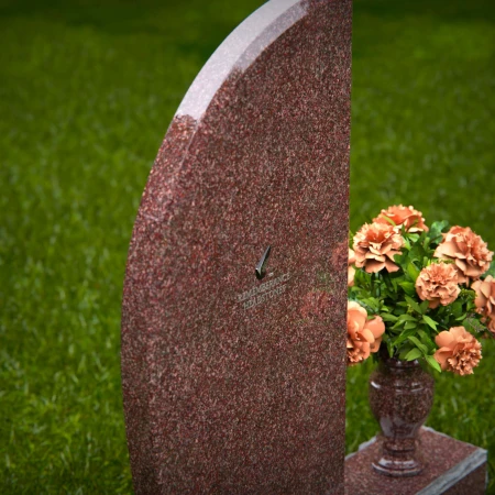 Contemporary headstones featuring sleek curves and floral vases.