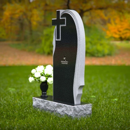 Graceful asymmetrical granite headstones with cross, symbolizing faith and remembrance.