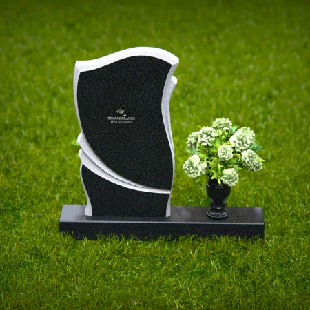 Elegant granite headstones with curved design and flower vase.