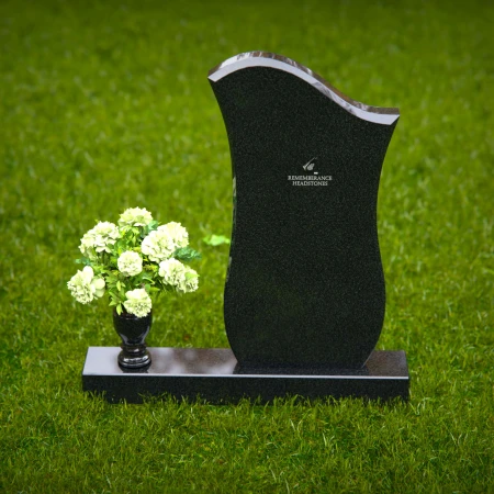 Contemporary granite headstones with unique curved design and vase.