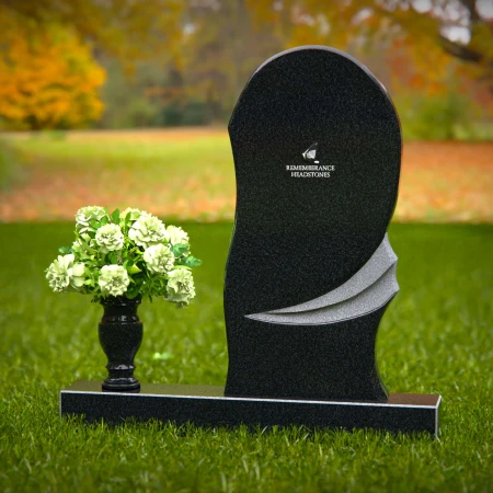 Contemporary headstones with curved artistic design and floral vase.