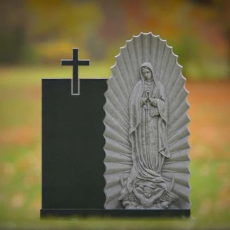Religious headstones featuring Virgin Mary and cross for sacred memorials.