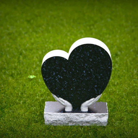 Comforting headstones with sculpted hands gently cupping heart