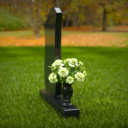 Contemporary granite headstones with unique curved design and vase.