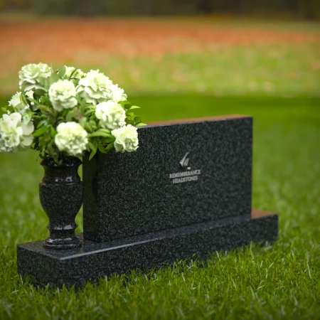 Elegant headstones featuring custom memorial designs and flower vases.