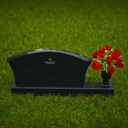 Contoured granite headstones with single flower vase for tribute.