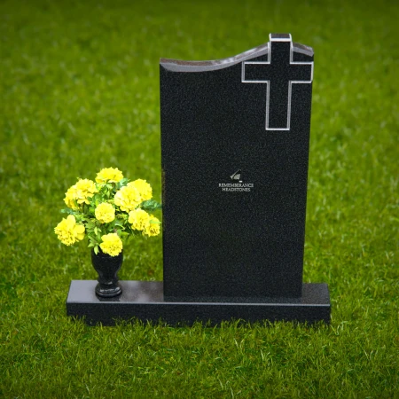 Upright granite headstones with cross design and flower vase.