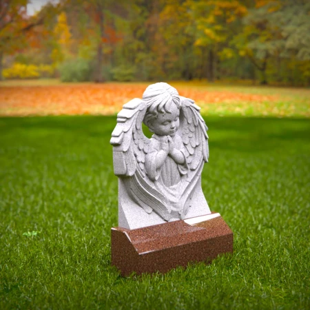 Reflective child tombstones carved with kneeling cherub angel