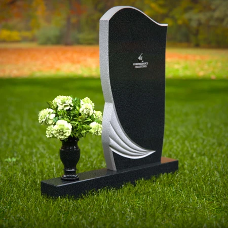 Artistic headstones with unique curved design and flower vase.