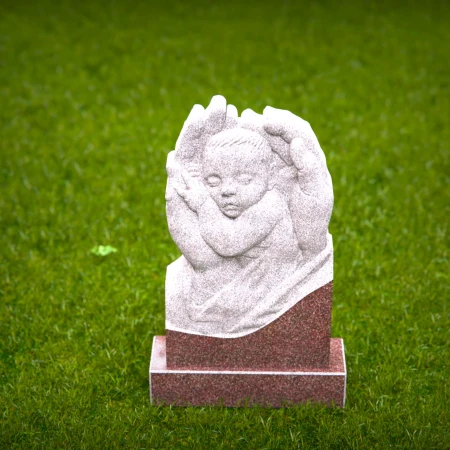 Sacred angel hands holding sleeping baby on headstones