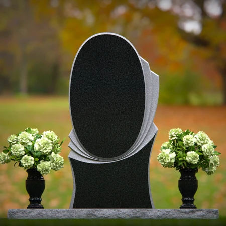 Modern oval granite headstones with layered base for elegant tribute.