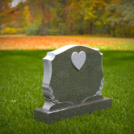 Memorial artistry flows through heart and leaf designs in headstones