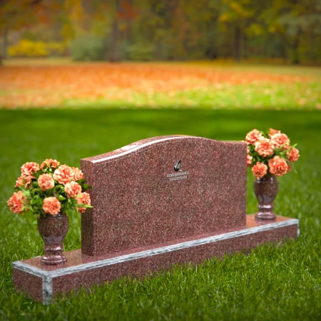 Artistic wave-top headstones with twin floral vases.