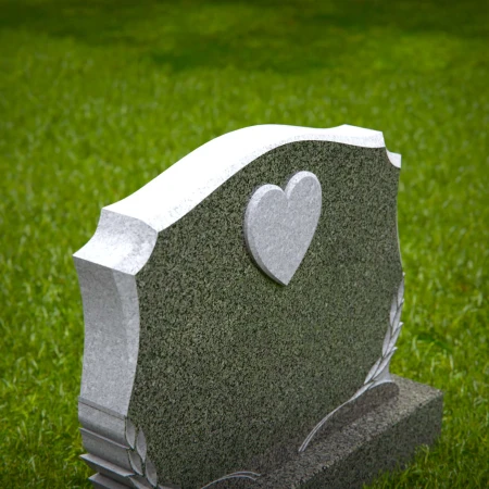 Memorial artistry flows through heart and leaf designs in headstones