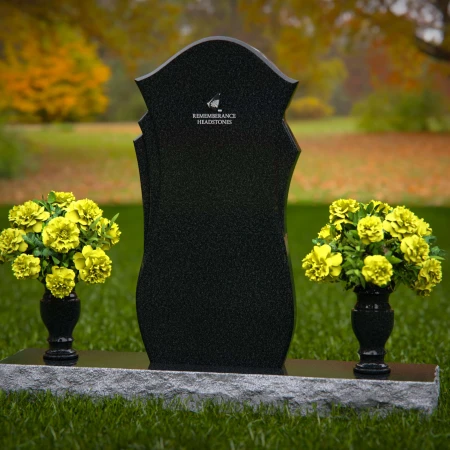 Unique shaped headstones with dual flower vases for memorial tribute.