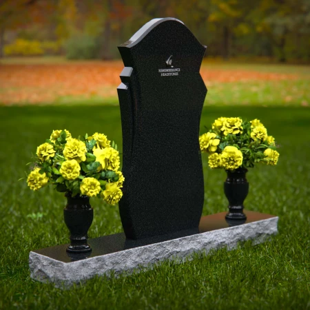 Unique shaped headstones with dual flower vases for memorial tribute.