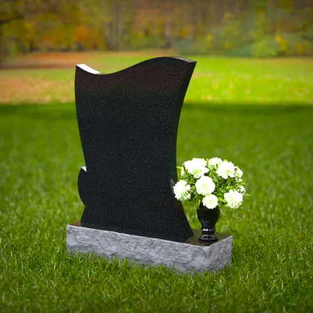 Elegant granite headstones with flowing contoured design and flower vase.