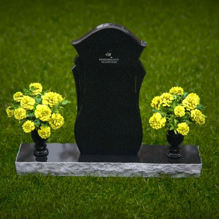 Unique shaped headstones with dual flower vases for memorial tribute.