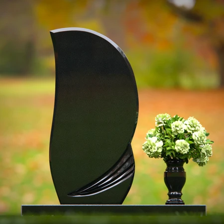 Modern curved headstones with single flower vase for memorials.