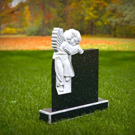 Carved children’s headstones with quiet angel watching over