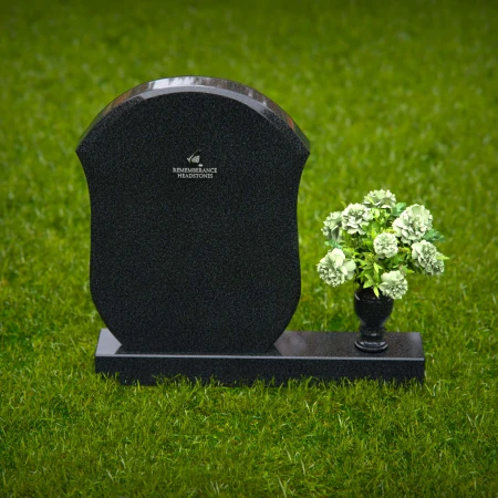 Unique granite headstones with rounded shield design and flower vase.