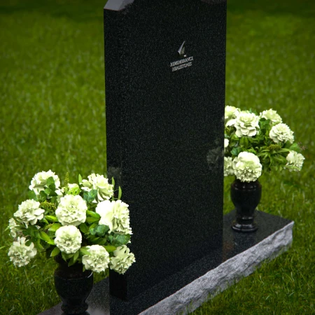 Elegant upright headstones with floral arrangement for timeless tribute.