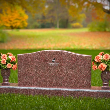 Artistic wave-top headstones with twin floral vases.