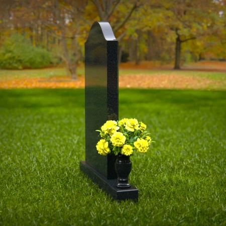 Elegant single granite headstones with curved top and flower vase.