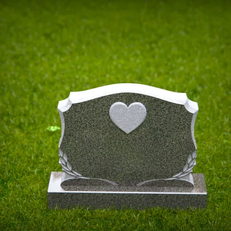 Memorial artistry flows through heart and leaf designs in headstones