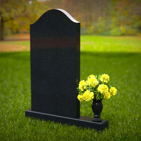 Elegant single granite headstones with curved top and flower vase.