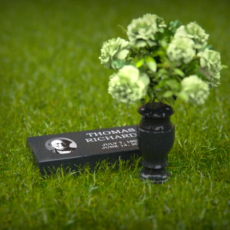Compact headstones featuring photo inlays and floral vases for memorials.
