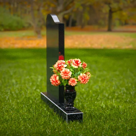 Curved granite headstones with elegant flower vase tribute.