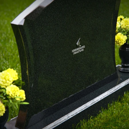 Waved granite headstones with dual flower vases for elegant tribute.