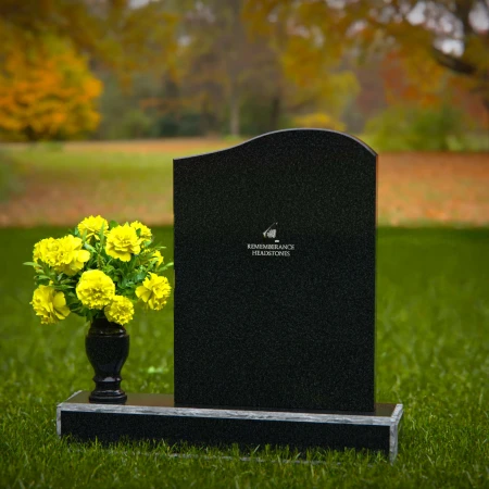 Elegant granite headstones with gently curved top and flower vase.